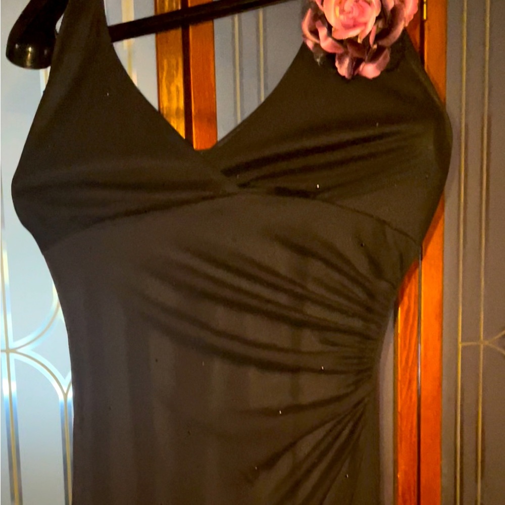 Black halter formal gown, with purple flower detail,mimicking a corsage pin.